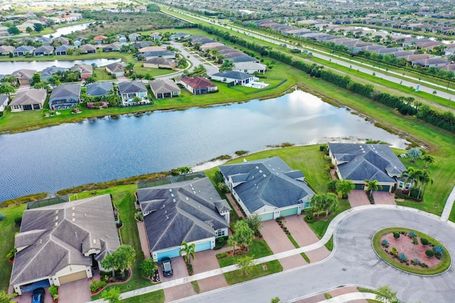 drone / aerial view featuring a residential view and a water view