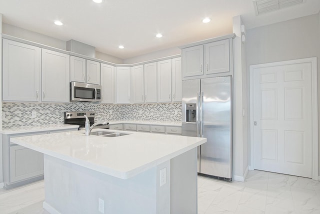 kitchen with visible vents, a sink, stainless steel appliances, light countertops, and marble finish floor