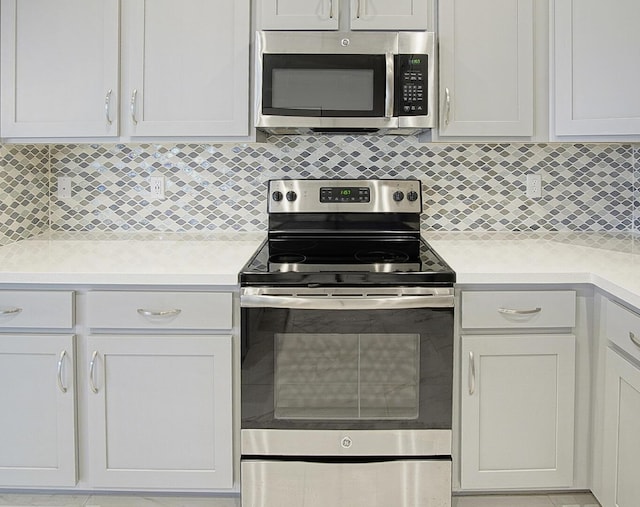 kitchen featuring backsplash, appliances with stainless steel finishes, and light countertops