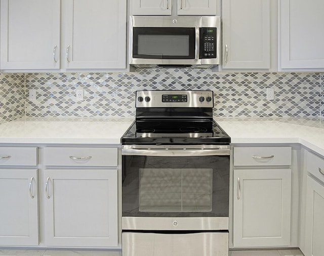 11243 SW Parkside Dr, Port Saint Lucie, FL 34987 - kitchen featuring stainless steel appliances, tasteful backsplash, and light countertops