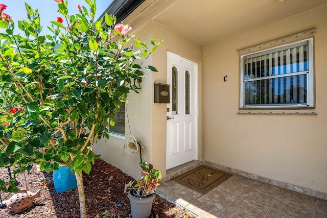 property entrance with stucco siding