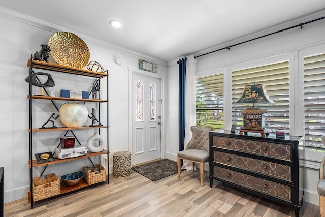 foyer featuring recessed lighting, baseboards, wood finished floors, and crown molding