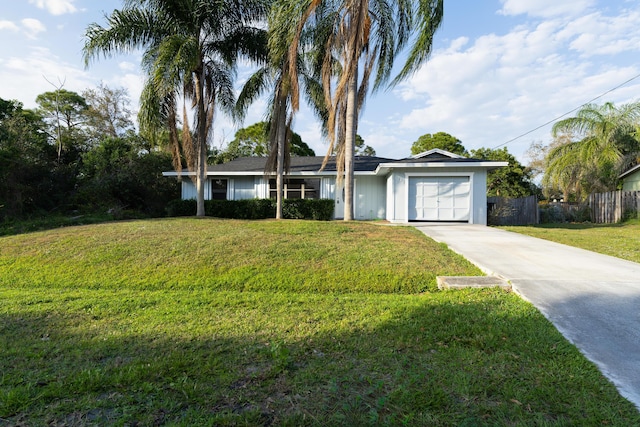 ranch-style home with concrete driveway, an attached garage, fence, and a front yard