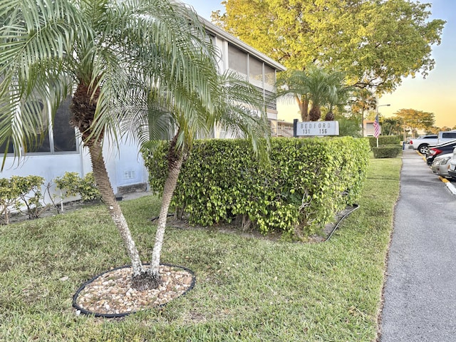 exterior space with stucco siding and a lawn
