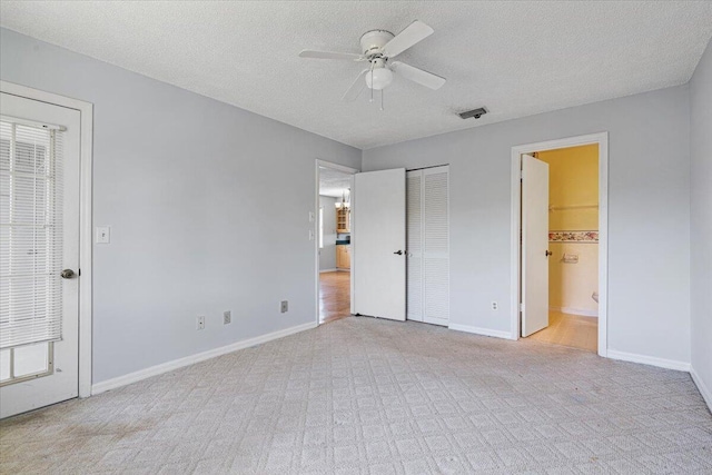 unfurnished bedroom featuring a textured ceiling and baseboards