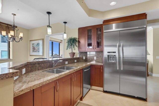 3620 Gardens Pkwy Unit 1001B, Palm Beach Gardens, FL 33410 - kitchen featuring stainless steel appliances, a sink, light stone countertops, and hanging light fixtures
