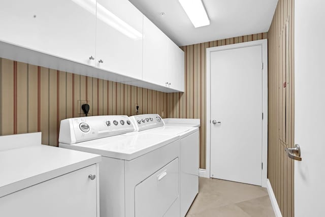 3620 Gardens Pkwy Unit 1001B, Palm Beach Gardens, FL 33410 - washroom with cabinet space, washing machine and clothes dryer, wallpapered walls, and baseboards