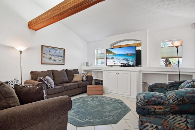 living area with light tile patterned flooring, a healthy amount of sunlight, and vaulted ceiling with beams