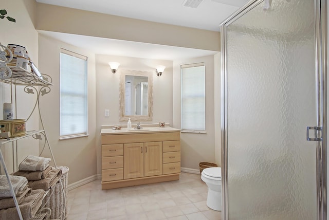 full bathroom featuring vanity, toilet, baseboards, and a stall shower