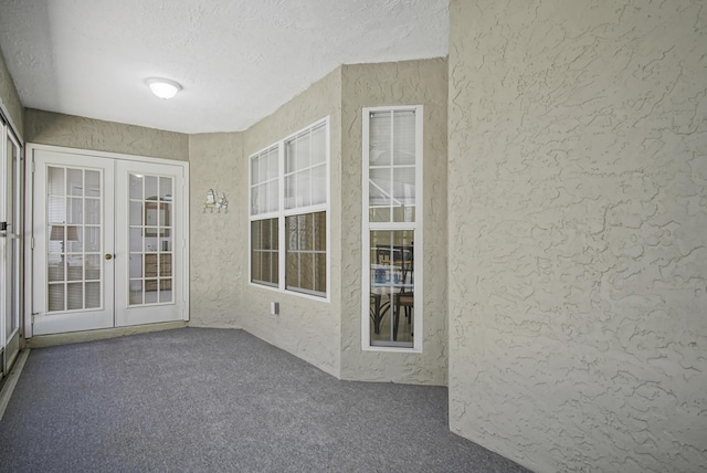 unfurnished sunroom with french doors