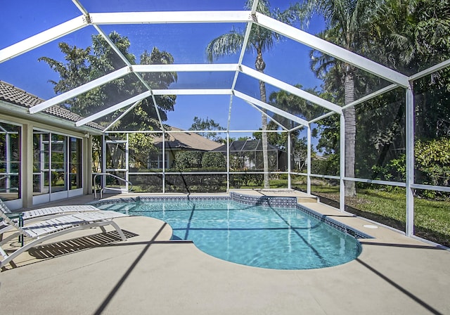 outdoor pool with a patio and a lanai