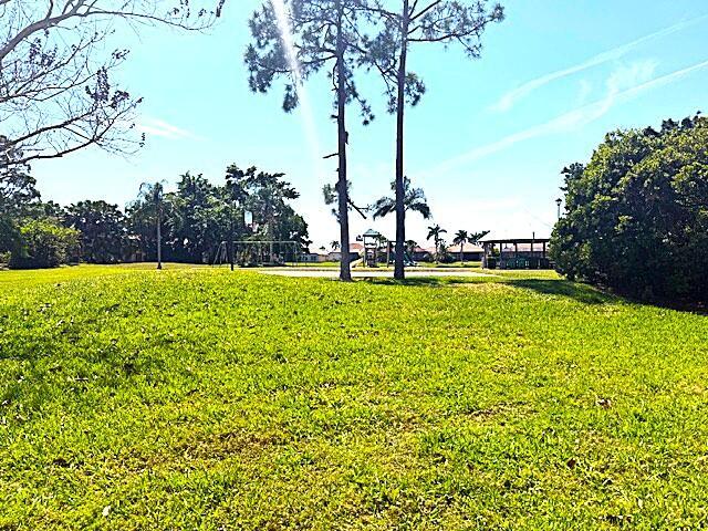 view of home's community with a yard