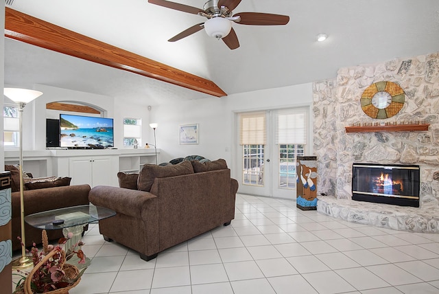 living room with light tile patterned floors, french doors, lofted ceiling, and a ceiling fan