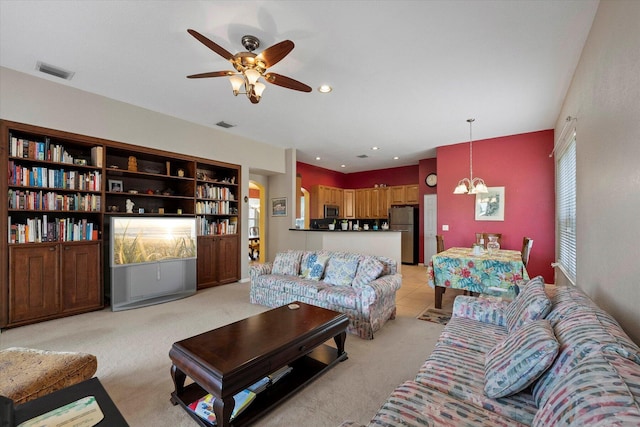 living area with recessed lighting, visible vents, light colored carpet, and ceiling fan with notable chandelier