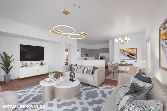 living room featuring a notable chandelier and wood finished floors