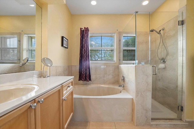 full bathroom featuring tile patterned flooring, a garden tub, recessed lighting, a stall shower, and vanity