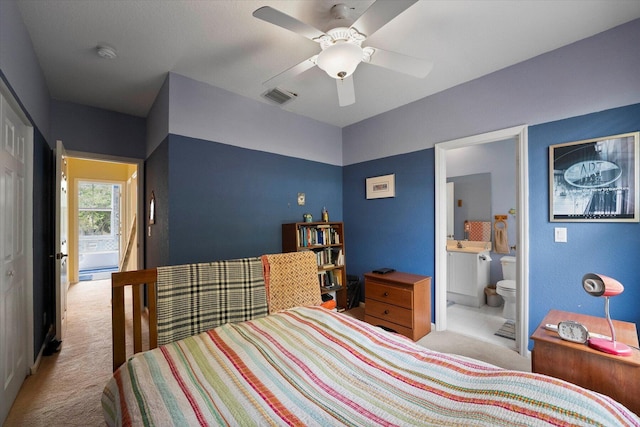 bedroom with a ceiling fan, carpet, visible vents, and connected bathroom