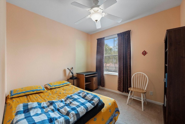 bedroom with light colored carpet, baseboards, and ceiling fan