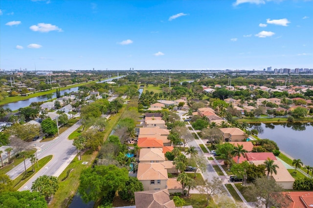 drone / aerial view featuring a residential view and a water view