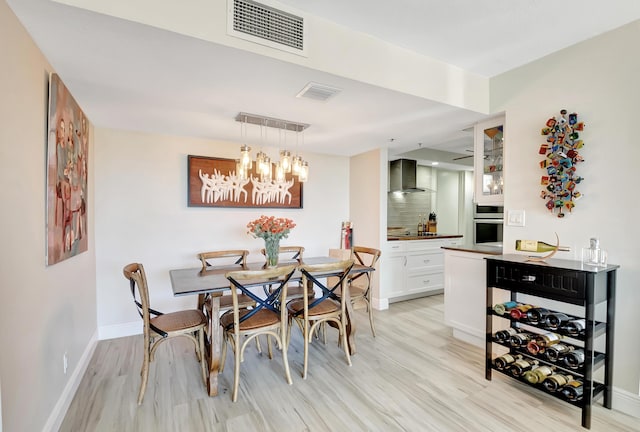 1523 Bridgewood Dr, Boca Raton, FL 33434 - dining area with a notable chandelier, baseboards, light wood finished floors, and visible vents