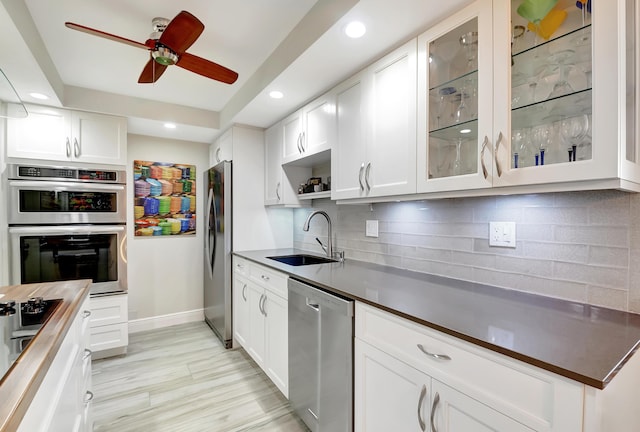 1523 Bridgewood Dr, Boca Raton, FL 33434 - kitchen featuring backsplash, a sink, dark countertops, a ceiling fan, and appliances with stainless steel finishes