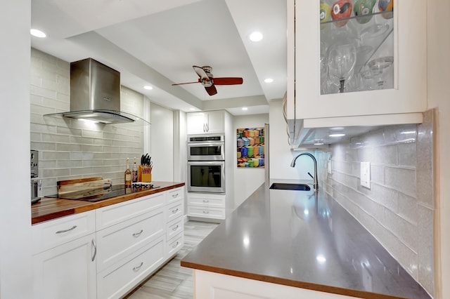1523 Bridgewood Dr, Boca Raton, FL 33434 - kitchen featuring a sink, double oven, wall chimney exhaust hood, black electric stovetop, and ceiling fan