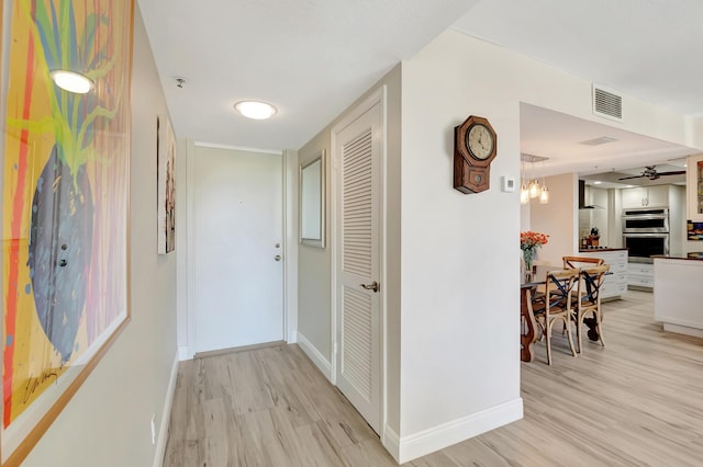 1523 Bridgewood Dr, Boca Raton, FL 33434 - corridor featuring baseboards, light wood finished floors, and visible vents
