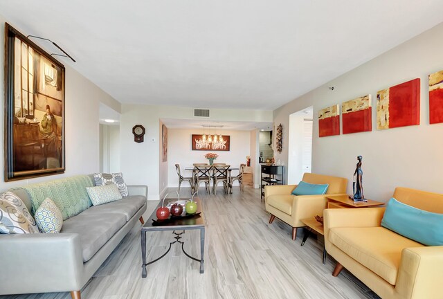 1523 Bridgewood Dr, Boca Raton, FL 33434 - living area featuring light wood-type flooring, a notable chandelier, baseboards, and visible vents