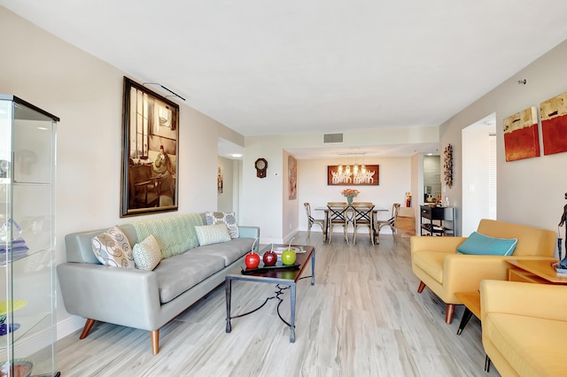 1523 Bridgewood Dr, Boca Raton, FL 33434 - living area with light wood finished floors, baseboards, visible vents, and an inviting chandelier