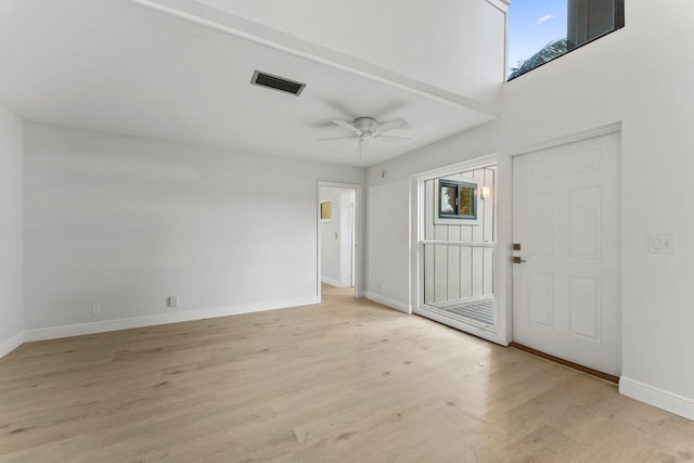 entrance foyer featuring a ceiling fan, baseboards, visible vents, and light wood finished floors