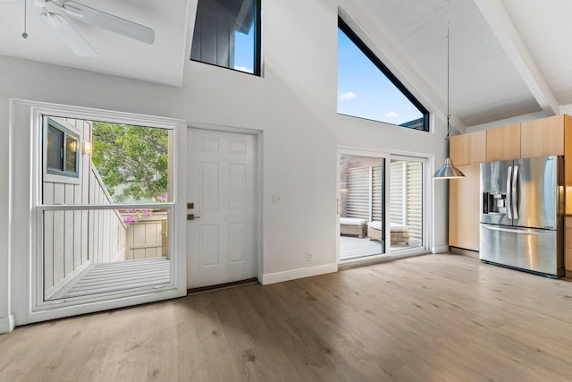 foyer featuring beam ceiling, baseboards, light wood-type flooring, and a ceiling fan