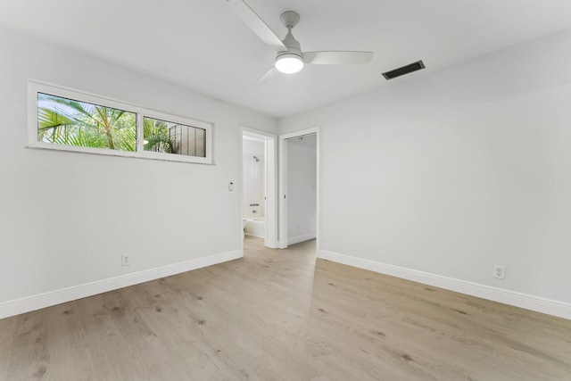 empty room with visible vents, baseboards, light wood-style flooring, and a ceiling fan