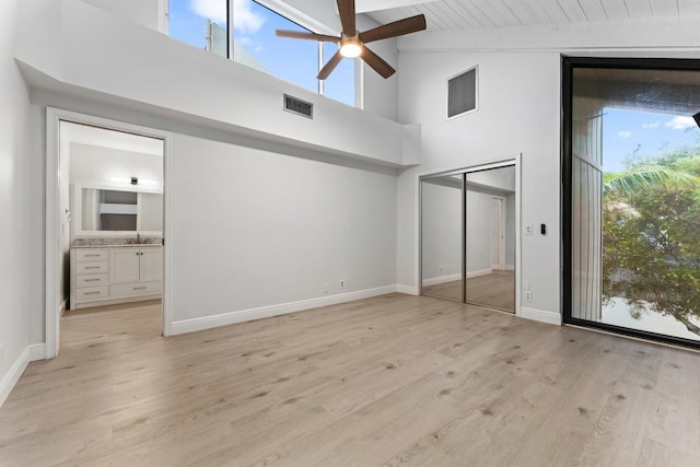 unfurnished bedroom featuring light wood-type flooring, visible vents, a sink, baseboards, and wood ceiling