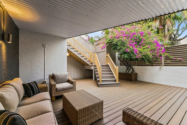 wooden deck featuring an outdoor living space and stairway