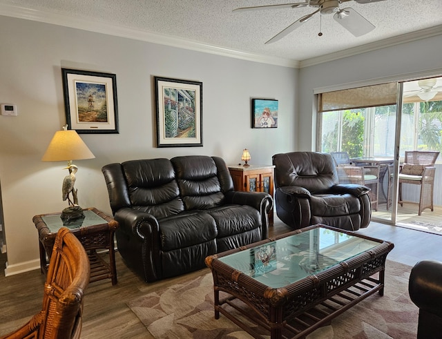 living room with crown molding, wood finished floors, a ceiling fan, and a textured ceiling