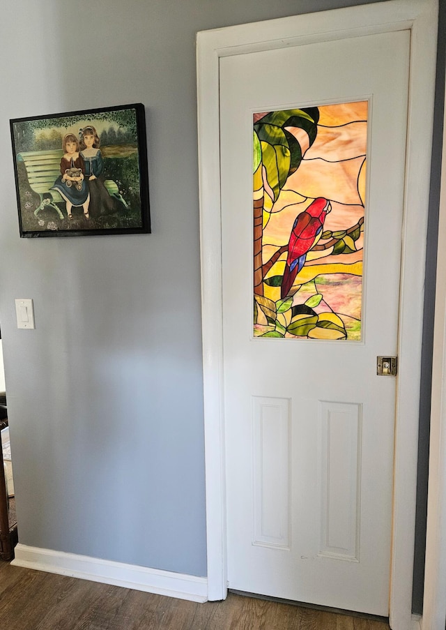 interior details with baseboards and wood finished floors