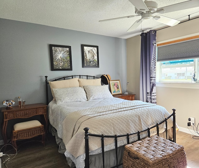 bedroom with baseboards, a textured ceiling, a ceiling fan, and wood finished floors