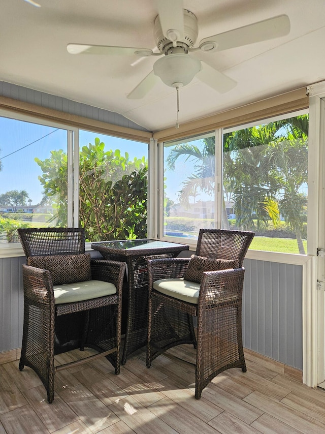 sunroom with a wealth of natural light, lofted ceiling, and a ceiling fan