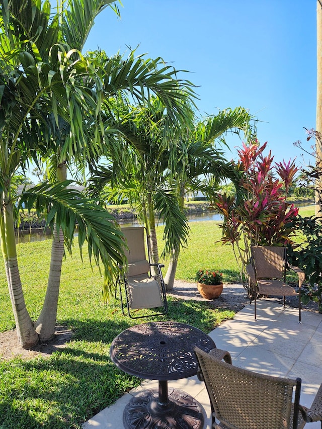 exterior space with a water view and a patio area