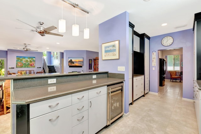 110 Dolphin Rd, Ocean Ridge, FL 33435 - kitchen with wine cooler, freestanding refrigerator, ceiling fan, white cabinetry, and decorative light fixtures