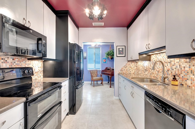 110 Dolphin Rd, Ocean Ridge, FL 33435 - kitchen featuring black appliances, a sink, decorative backsplash, and white cabinets