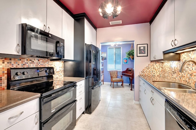 110 Dolphin Rd, Ocean Ridge, FL 33435 - kitchen with black appliances, a sink, tasteful backsplash, and white cabinets