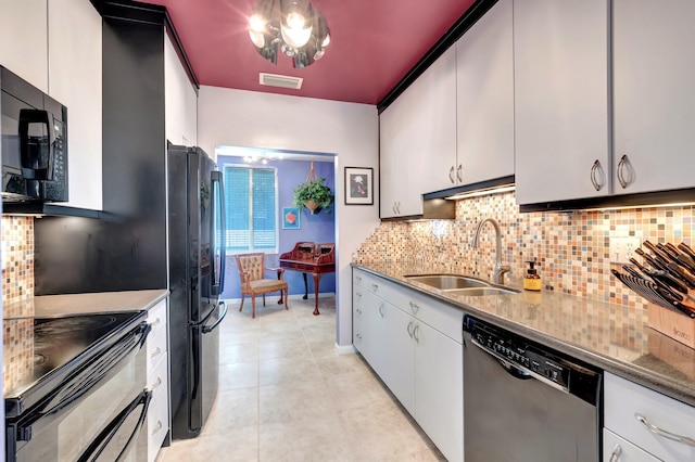 110 Dolphin Rd, Ocean Ridge, FL 33435 - kitchen featuring black appliances, a sink, decorative backsplash, and light tile patterned floors
