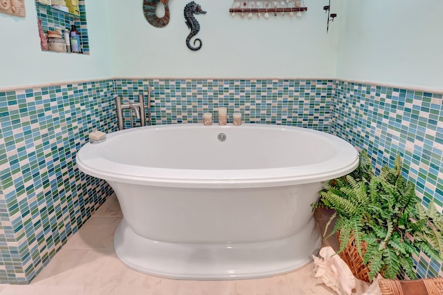 110 Dolphin Rd, Ocean Ridge, FL 33435 - full bathroom with tile walls, a freestanding tub, tile patterned flooring, and a wainscoted wall