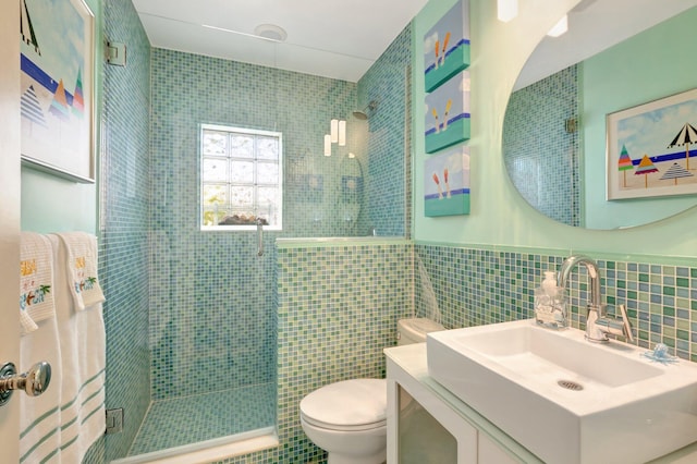 110 Dolphin Rd, Ocean Ridge, FL 33435 - bathroom with toilet, a shower stall, tile walls, vanity, and wainscoting