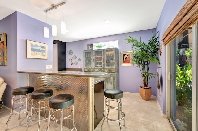 110 Dolphin Rd, Ocean Ridge, FL 33435 - indoor bar with baseboards, decorative light fixtures, light tile patterned floors, and plenty of natural light