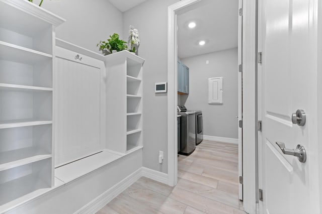 mudroom featuring washing machine and dryer, baseboards, and recessed lighting