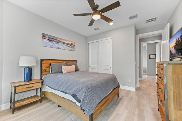 bedroom featuring light wood-style floors, a closet, and visible vents