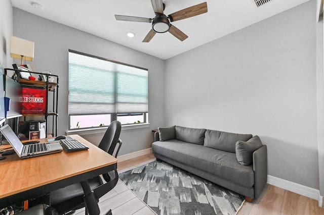 office area featuring baseboards, ceiling fan, and wood finished floors
