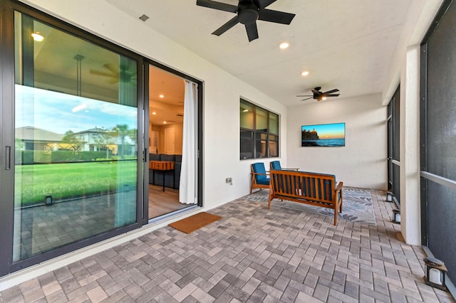 sunroom featuring brick floor and recessed lighting